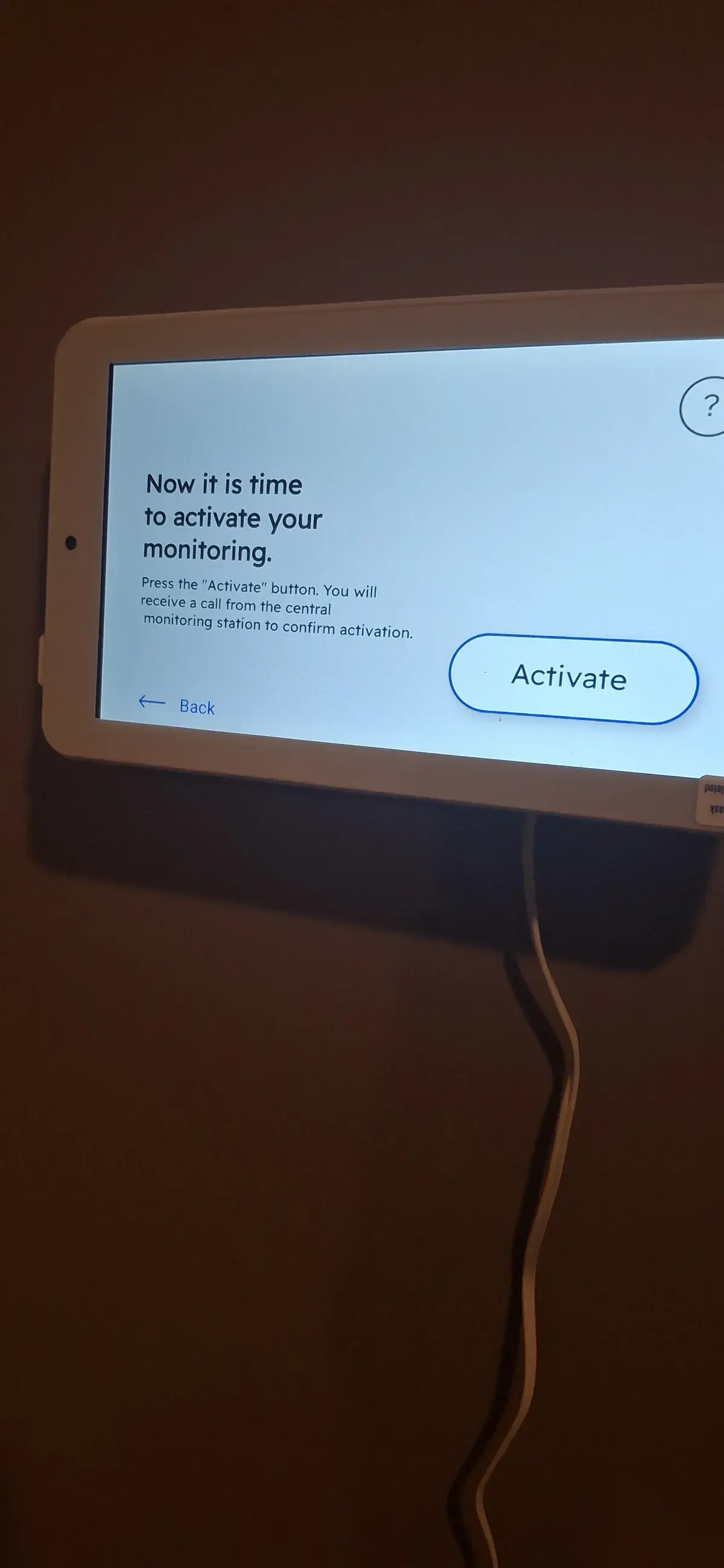 Security system touchscreen panel showing the monitoring activation step during setup