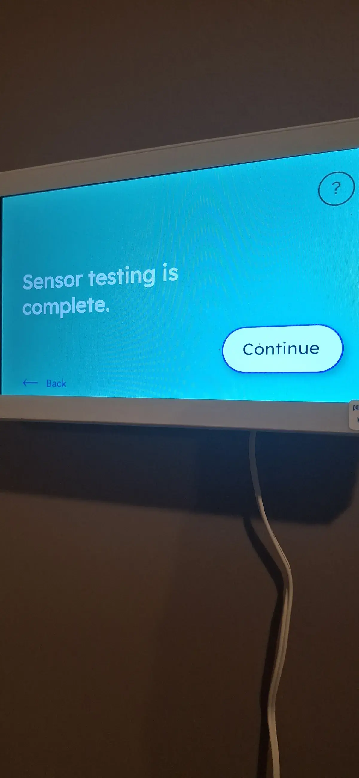 Wall mounted security touchscreen panel showing sensor testing complete