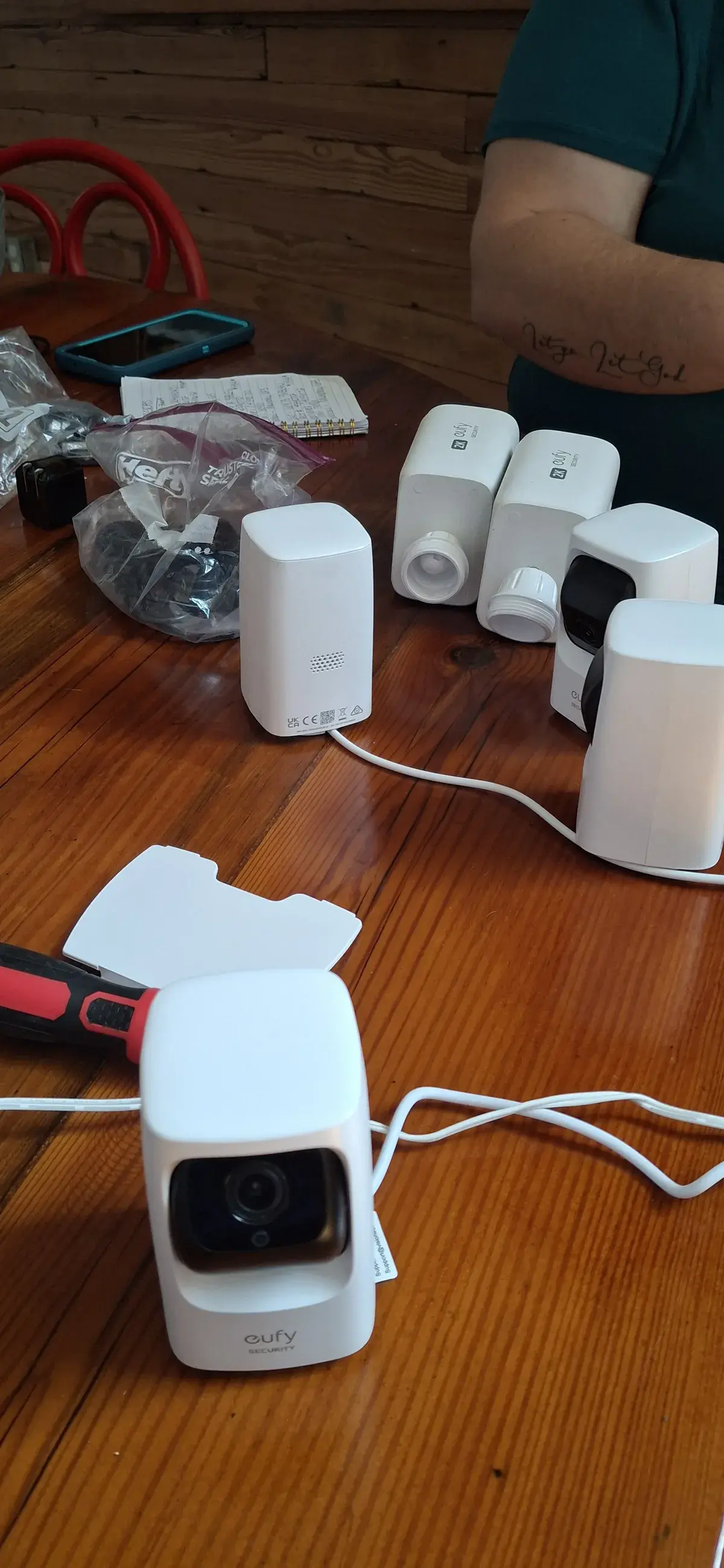 Eufy security cameras unboxed and laid out on a kitchen table part way through an install